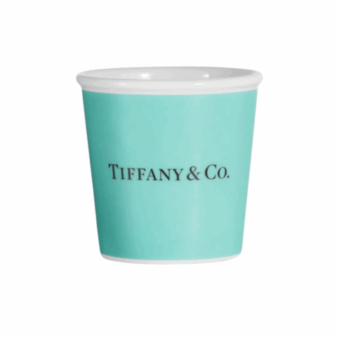 A turquoise espresso cup with the words "Tiffany & Co." on the front.