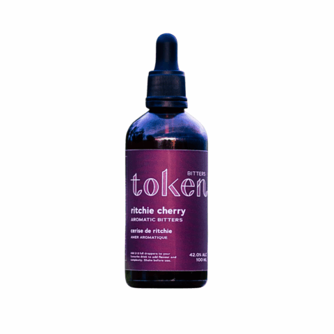 A bottle of bitters with a purple label and black dropper cap.