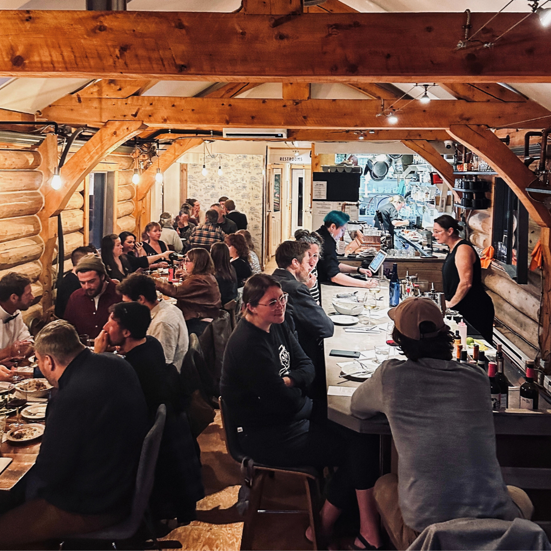 Full restaurant interior with wooden ceilings.