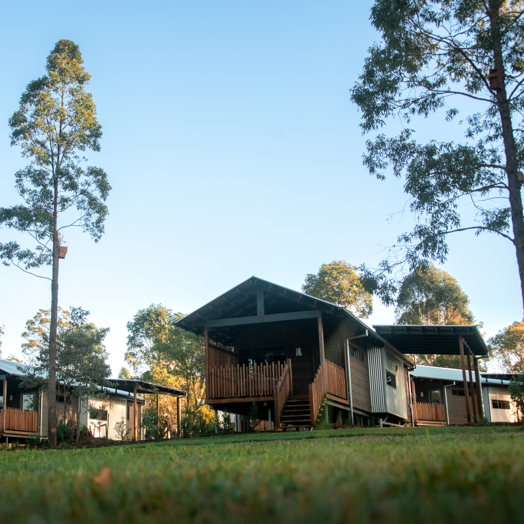 A wooden lodge with other lodges around it.