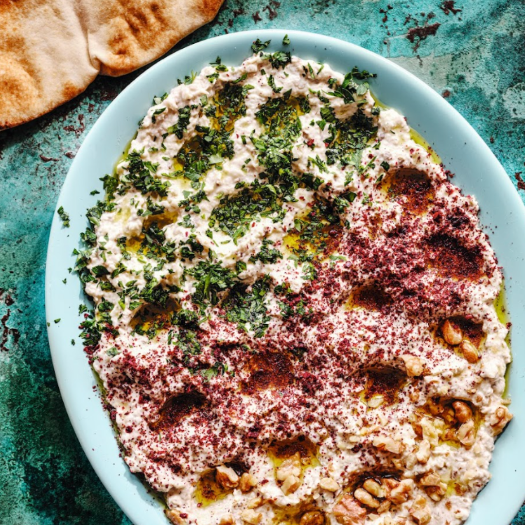 Eggplant and yogurt meze dip topped with sumac, olive oil, pine nuts and herbs. Served with pita bread.