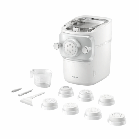 A white pasta machine with pasta extruders and tools.