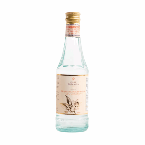 A clear bottle with a gold cap and peach-coloured label.
