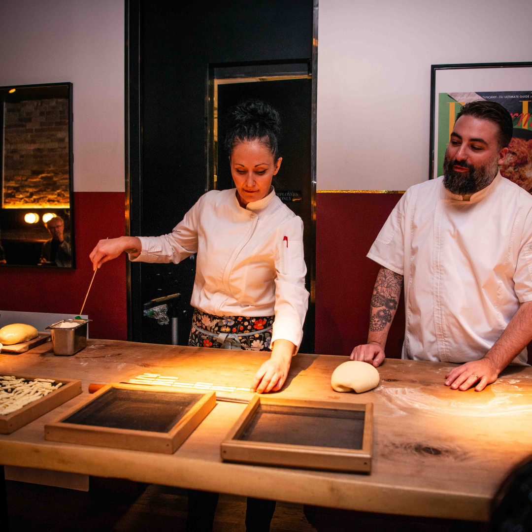 Two chefs pasta-making by hand at the ELLE Gourmet event