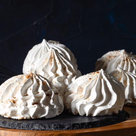 Chewy, fragrant, and easy 3-ingredient almond meringue cookies against a black background