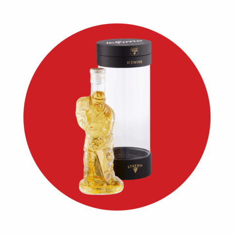 Yellow ice wine in a bottle shaped like a hockey player, next to its packaging.