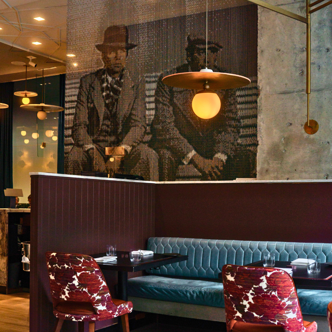 Michelin-recommended Lucie Restaurant interior with blue velvet banquettes and red cut velvet chairs