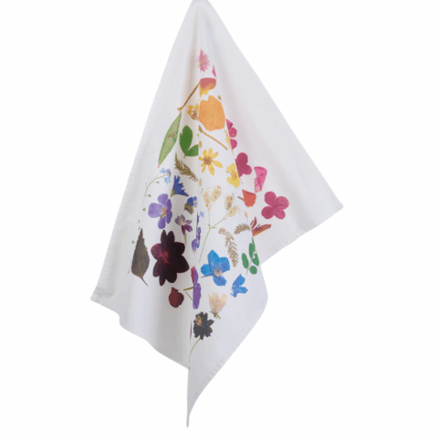 Tea towel is a hanging rainbow print of real botanicals