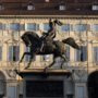 Equestrian statue in front of a grand neoclassical building — view of a historic Turin piazza.
