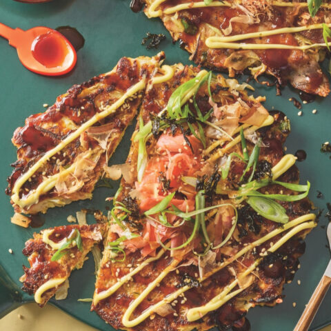 Japanese okonomiyaki cabbage pancakes topped with Kewpie mayo, okonomiyaki sauce, green onions and pickled ginger.