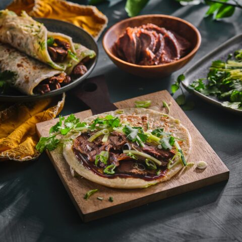 Taiwanese beef rolls with braised beef cheeks, scallion pancakes, cucumber and cilantro